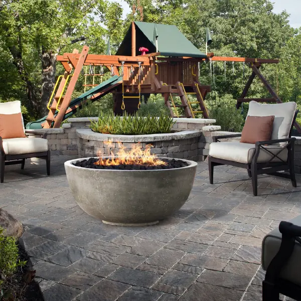 outdoor-living-xo-fire-table Outdoor Living Products - Fire Table with chairs on patio with garden